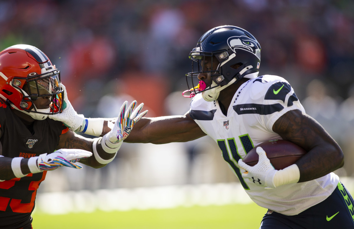 Seattle Seahawks wide receiver D.K. Metcalf (14) stiff arms Cleveland Browns strong safety Damarious Randall (23) during the first quarter at FirstEnergy Stadium. 